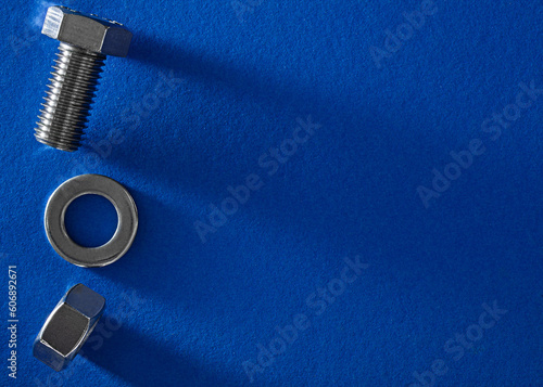 Bolt and nut on blue background 
