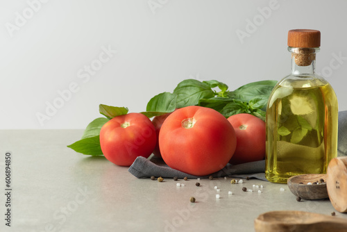 Culinary background with vegetable oil, spices and towel. Gray wall and table