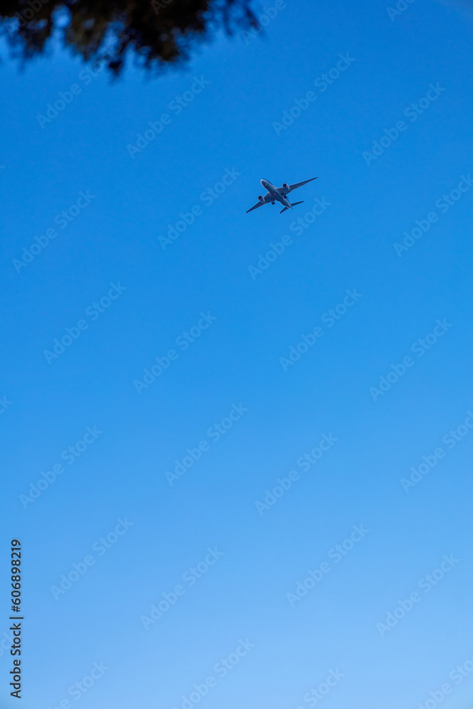 View of airplane flying in blue sky. Vertical photo. High quality photo View of airplane flying in blue sky. Vertical photo. High quality photo