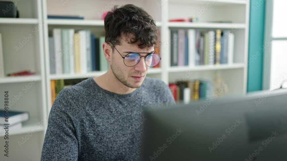 Young hispanic man student upset using laptop at library university Young hispanic man student upset using laptop at library university