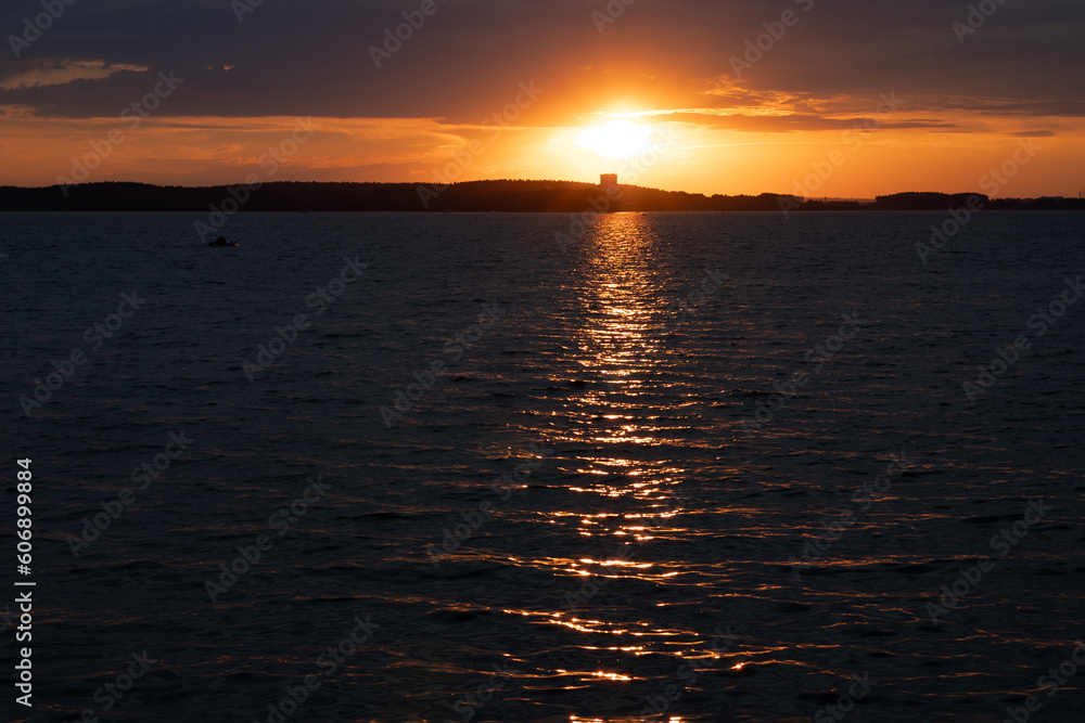 Evening landscape, sunrise or sunset on the lake or the sea