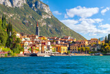 The skyline and beach of the colorful Italian lakefront resort village of Varenna, Italy at summer on the shores of Lake Como.