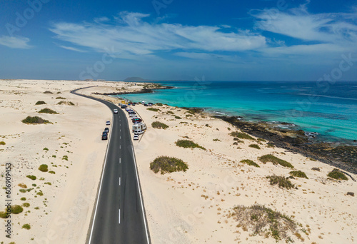 Aerial mid level panoramic view of Moro Beach and the road between the coast and Parque Natural sand dunes heading to Corralejo Fuerteventura Spain © Dave