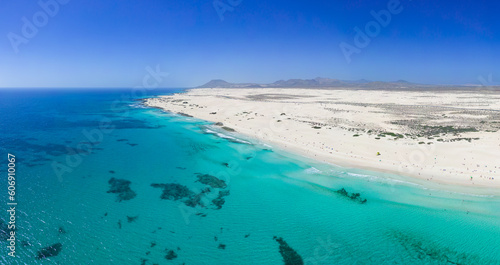 Beautiful mid level aspect aerial panoramic view of Grandes Playa beach with clear turquoise water near Corralejo in Fuerteventura Spain photo