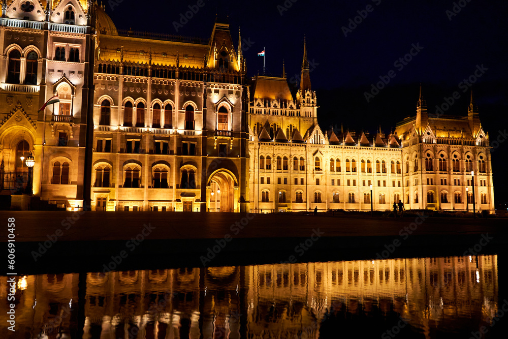 A fabulous nighttime photo of the illuminated facade of the parliament building in Budapest, reflected in the water