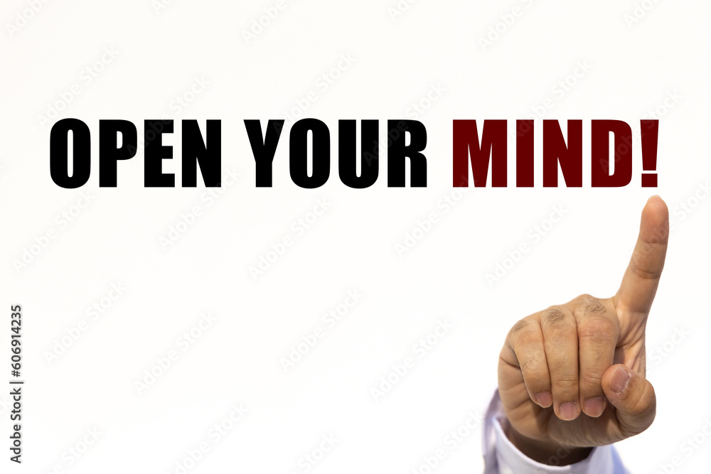 Open your mind text on white wall background with businessman's finger point at the message with empty space. This message can be used as business concept about opening your mind. Open your mind text on white wall background with businessman's finger point at the message with empty space. This message can be used as business concept about opening your mind.