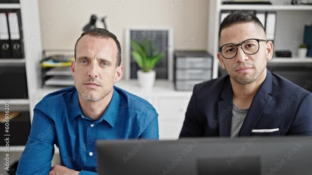 Two men business workers working with relaxed expression at office Two men business workers working with relaxed expression at office