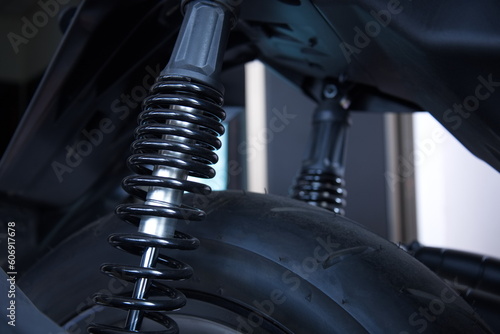 Motorcycle rear spring shock absorber. Motorcycle rear wheel suspension with copy space with selective focus