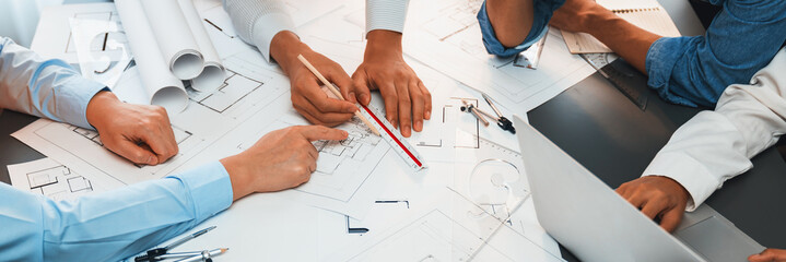 Architect or engineer working on building blueprint, contractor designing and drawing blueprint layout with tool for construction project. Civil engineer and architecture design concept. Insight