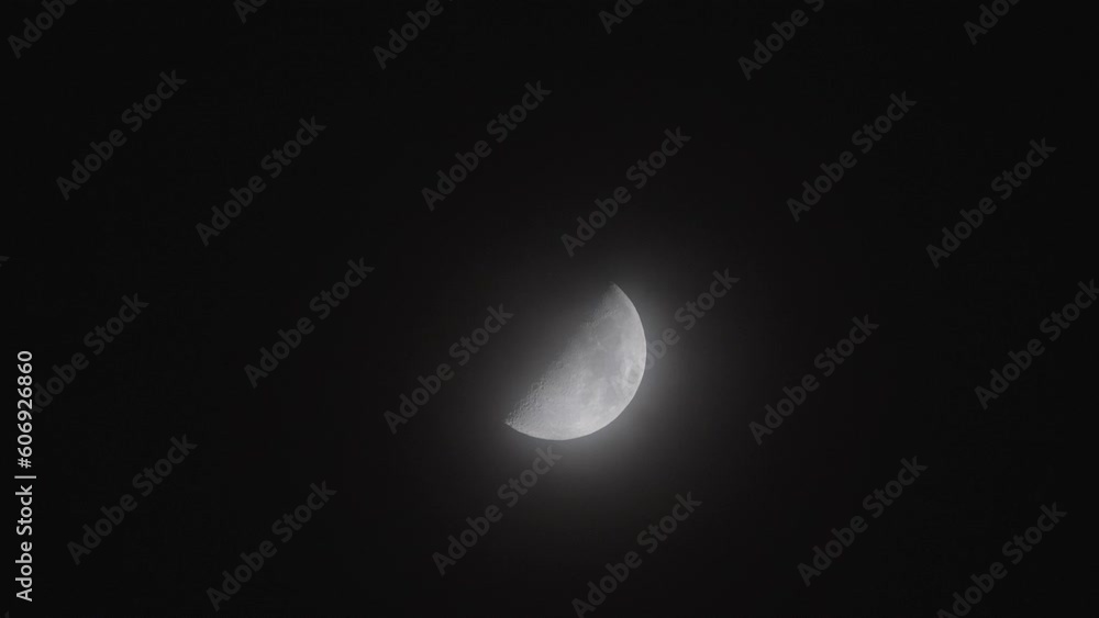 Close up of half moon with black sky background at night, clouds moving and moon light shining, telephoto lens 4k time lapse footage. Close up of half moon with black sky background at night, clouds moving and moon light shining, telephoto lens 4k time lapse footage.