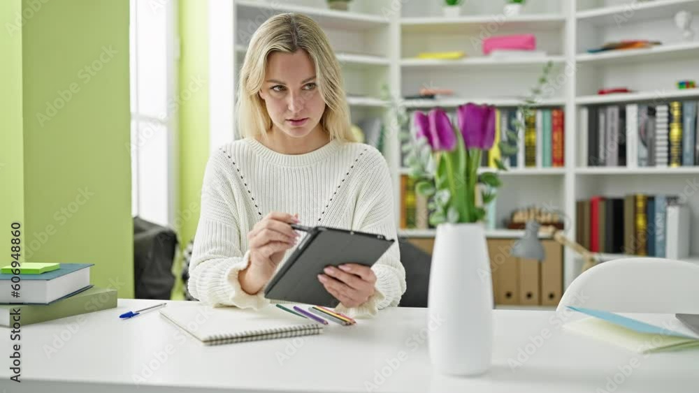 Young blonde woman student drawing flower pot on touchpad at library university Young blonde woman student drawing flower pot on touchpad at library university