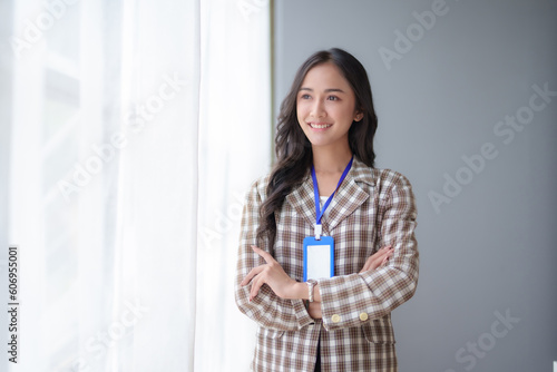Free Download Portrait of young beautiful Asian businesswoman in the office. Crossed arms. Successful Asia business woman confident smiling. - GFXLoad