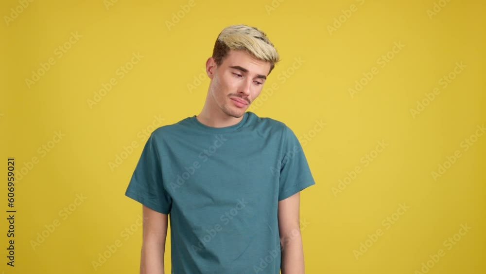 Sad gay man standing and looking at camera Sad gay man standing and looking at camera