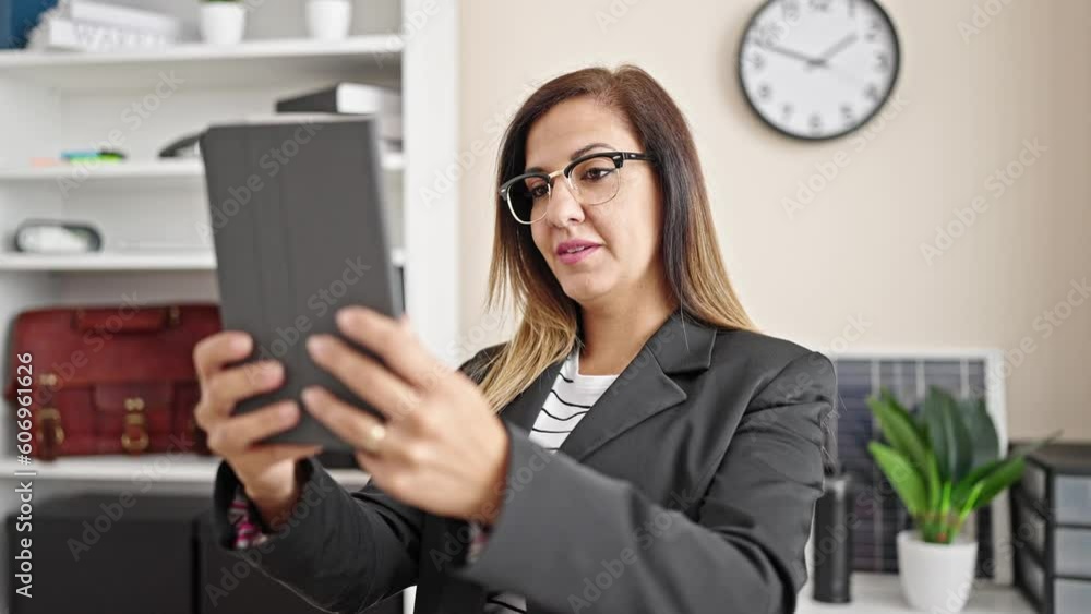 Middle eastern woman business worker combing hair with hand make selfie by touchpad at office Middle eastern woman business worker combing hair with hand make selfie by touchpad at office