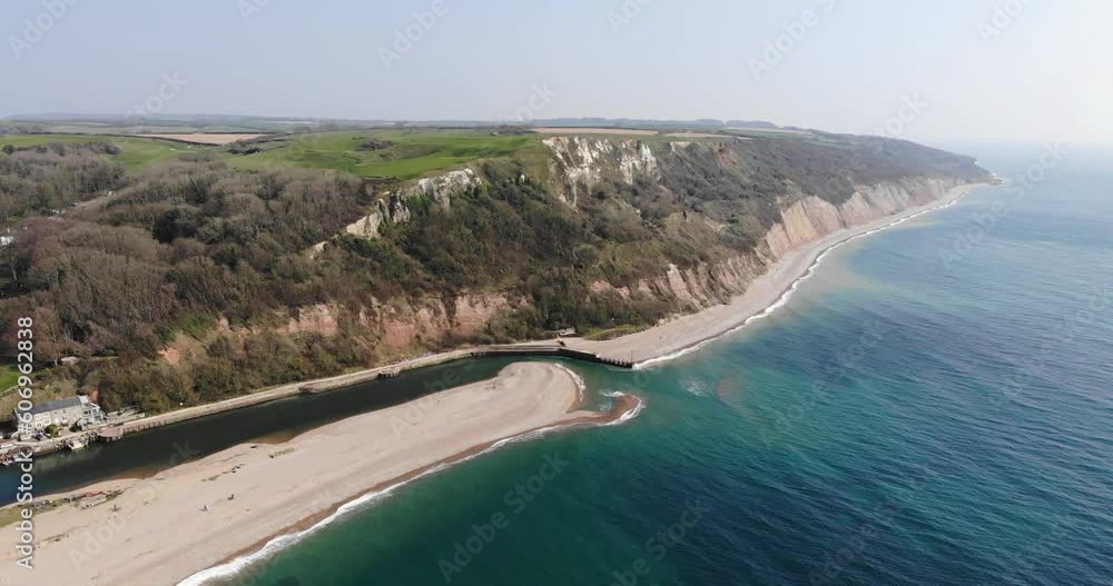 Aerial View Along River Axe Mouth And Haven Cliffs In Seaton. Slow Dolly Forward Aerial View Along River Axe Mouth And Haven Cliffs In Seaton. Slow Dolly Forward
