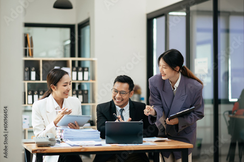 Asian business team meeting,work process.professional crew working with new startup project.Project managers. business plans, Laptop nad smartphone hands..