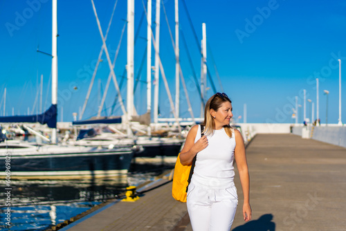 Beautiful woman on vacation walking in marina  © Jacek Chabraszewski