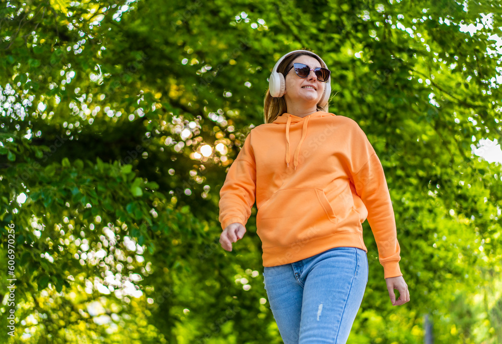 Beautiful woman walking in city park
Beautiful woman walking in city park