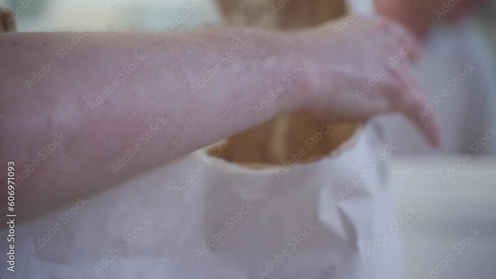 white bag of flour is torn open by a baker in a bakery white bag of flour is torn open by a baker in a bakery