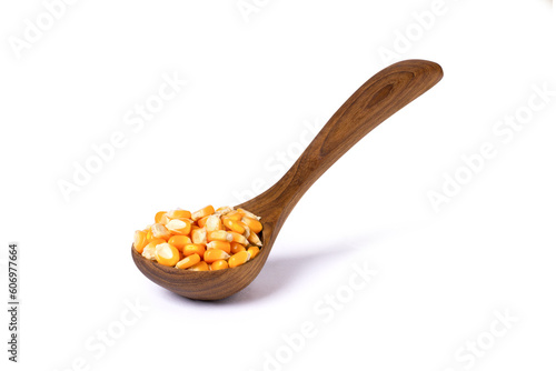 Dried corn seeds (raw popcorn grains) in wooden spoon isolated on white background with clipping path.