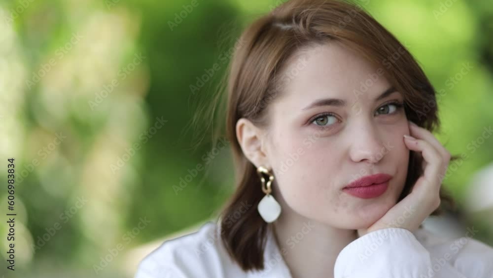 beautiful woman close-up with red lips on natural background. Young woman romantically fantasizes beautiful woman close-up with red lips on natural background. Young woman romantically fantasizes