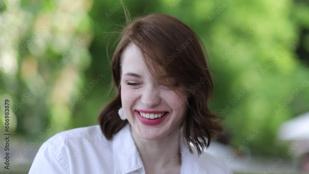 beautiful young woman smiling while sitting on the terrace on a summer day with a cup of coffee, the concept of a cheerful morning and breakfast. beautiful young woman smiling while sitting on the terrace on a summer day with a cup of coffee, the concept of a cheerful morning and breakfast.