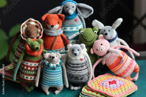 Crochet stuffed animals close up photo. Hand made Amigurumi toys on dark background with copy space. Cute crochet gift.  © Maya