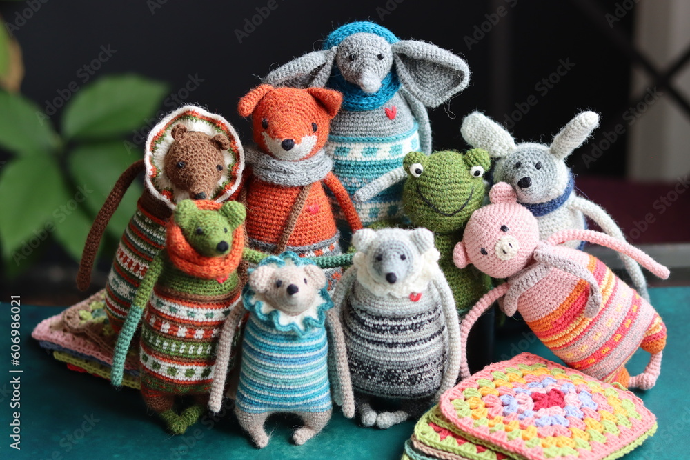 Crochet stuffed animals close up photo. Hand made Amigurumi toys on dark background with copy space. Cute crochet gift. Crochet stuffed animals close up photo. Hand made Amigurumi toys on dark background with copy space. Cute crochet gift.