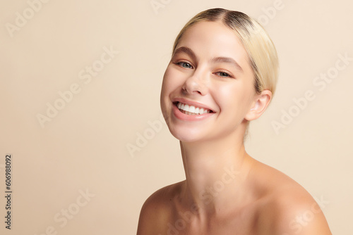 Beautiful smile of young woman with healthy white teeth on beige background, Dental care. Dentistry concept.