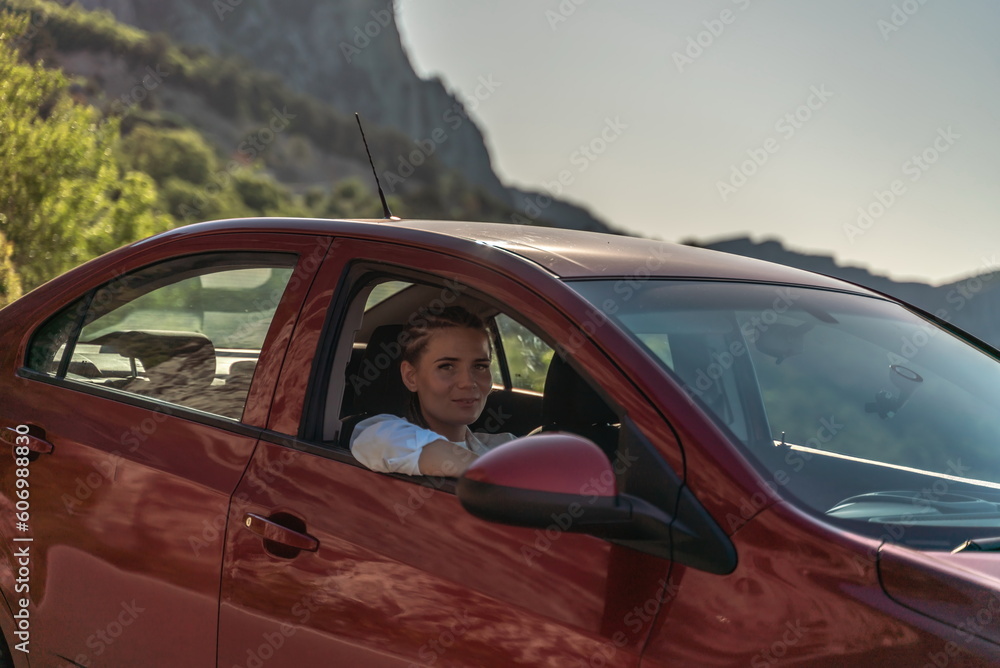 Woman driving a car. A lady in sunglasses takes the wheel of her