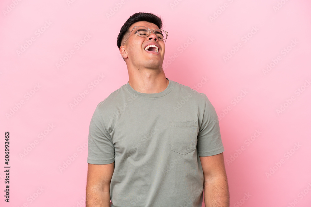 Obraz premium Young caucasian handsome man isolated on pink background laughing