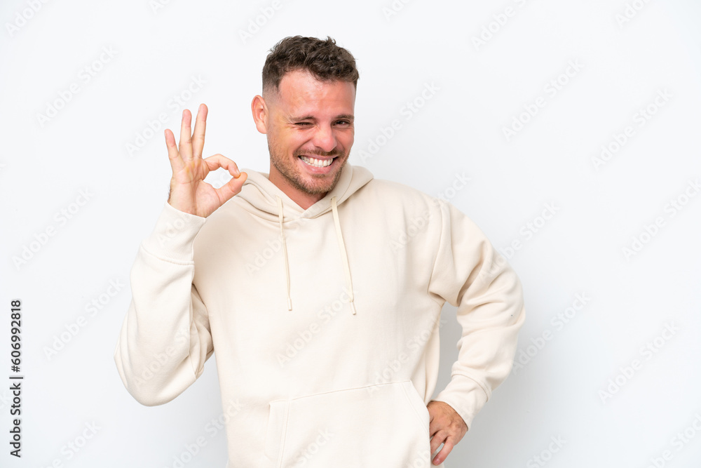 Young caucasian handsome man isolated on white background showing ok sign with fingers Young caucasian handsome man isolated on white background showing ok sign with fingers