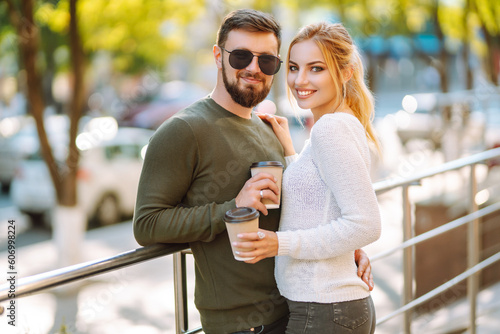 Stylish couple in love outdoors and drinking coffee. Youth, love, time together, lifestyle. © maxbelchenko