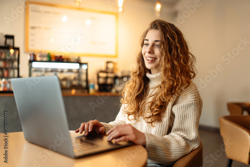 Young woman with laptop in cafe.  Business, blogging, freelancing, education concept.