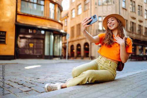 Selfie time. A tourist walks the streets and takes selfie using smartphone camera. Lifestyle, travel, tourism, active life.