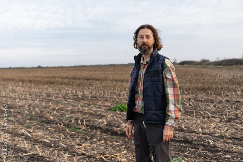 Portrait of bearded farmer on a field 