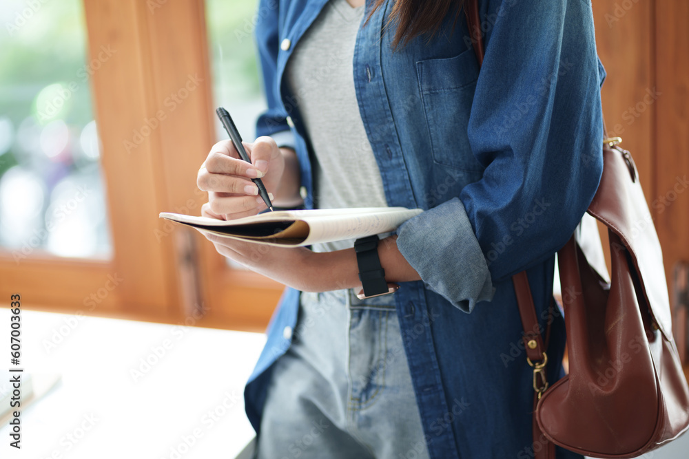 Portrait of Female Asian university taking notes.. Portrait of Female Asian university taking notes..