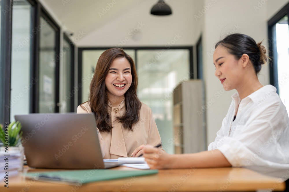 Two business women sit and discuss plans for a new project. Brainstorm and share ideas. Two business women sit and discuss plans for a new project. Brainstorm and share ideas.