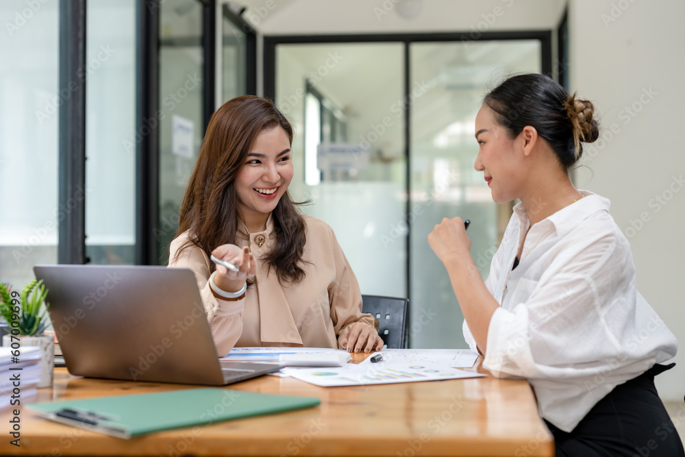 Two business women sit and discuss plans for a new project. Brainstorm and share ideas. Two business women sit and discuss plans for a new project. Brainstorm and share ideas.
