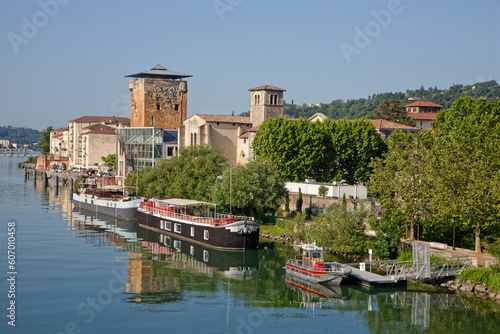 VIENNE, FRANCE, May 26, 2023 : Valois tower, built in 1336 by French King Philippe VI and Cordeliers church on the right bank of Rhone river. photo