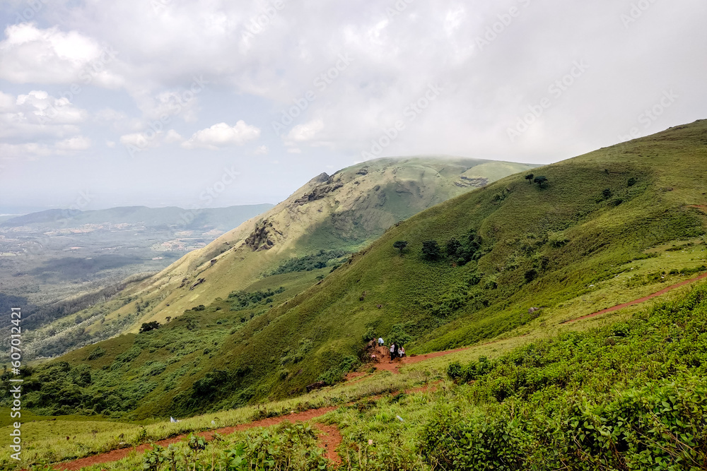 Green grass hills and blue sky with clouds, Amazing nature landscape.