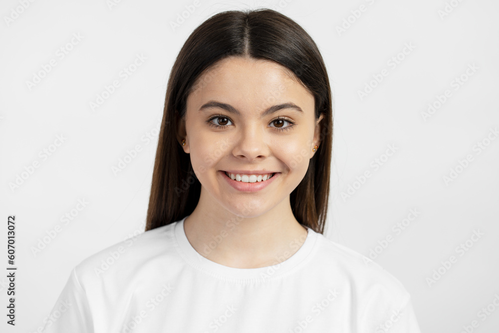 Closeup portrait of smiling hispanic teenage girl isolated on white background. Health care, morning routine, dental concept Closeup portrait of smiling hispanic teenage girl isolated on white background. Health care, morning routine, dental concept