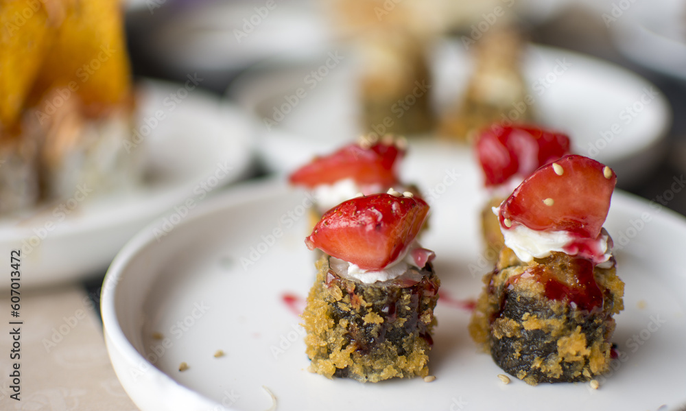 Fried sushi with strawberries on the top Fried sushi with strawberries on the top