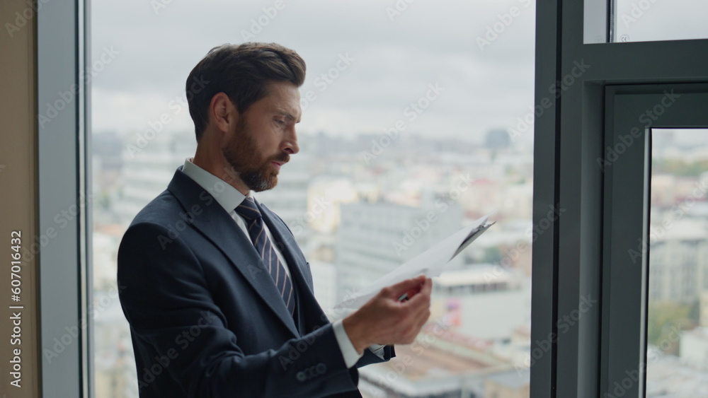 Auditor checking financial documents standing smiling at office window close up. Auditor checking financial documents standing smiling at office window close up.