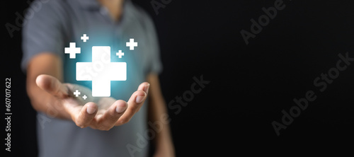 Man with cross shape and healthcare icons on hand. Virtual medical healthcare. Network connection online communication to hospital.