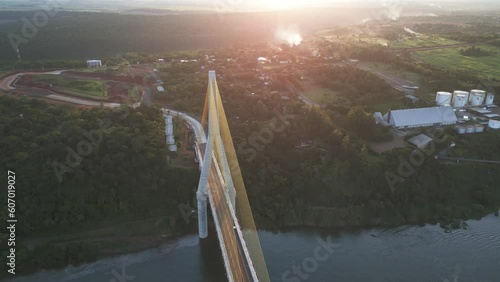 Aerial Drone Fly Above Bridge Junction of Triple Frontier in Brazil Paraguay and Argentina, Sunrise Landscape in Rivers of South American Borders photo