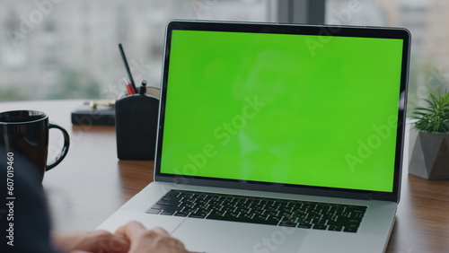 Fotografie Businessman working greenscreen laptop in office close up