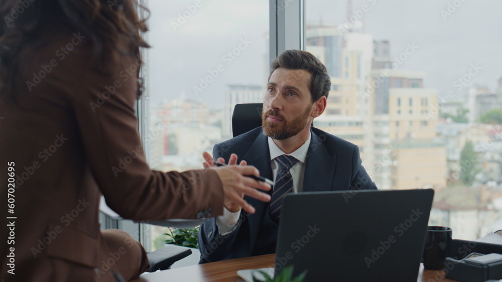 Fototapeta premium Relaxed coworkers communicating office closeup. Woman sharing ideas with manager