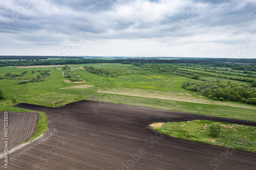 Obraz na płótnie Top view of plowed and sown fields w salonie
