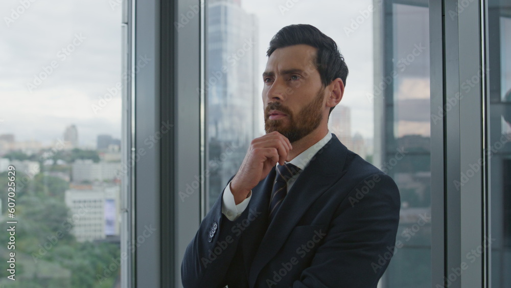 Thoughtful ceo director looking on city view standing near office window closeup Thoughtful ceo director looking on city view standing near office window closeup